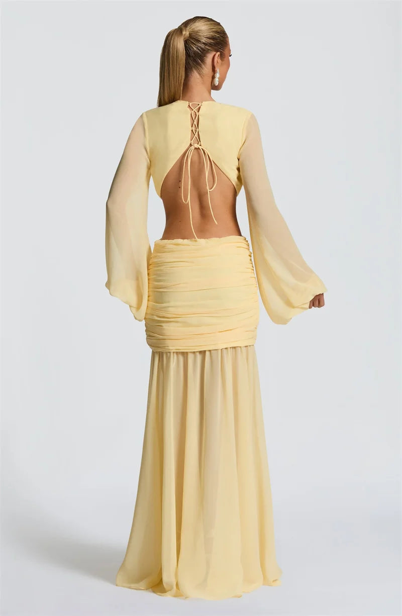 Yellow dress with long sleeves and a high neckline on a white background