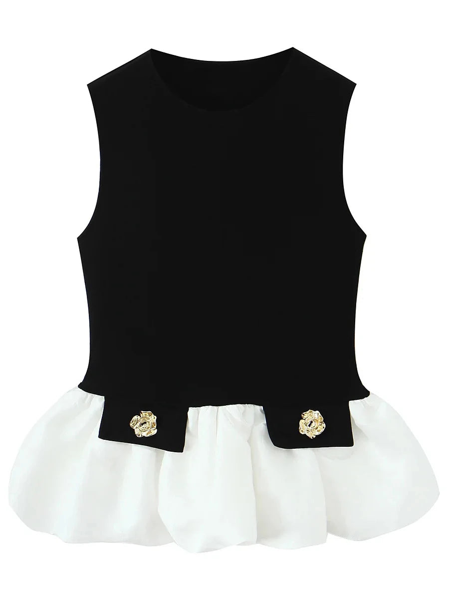 Black top with white hem and gold floral accents on a white background