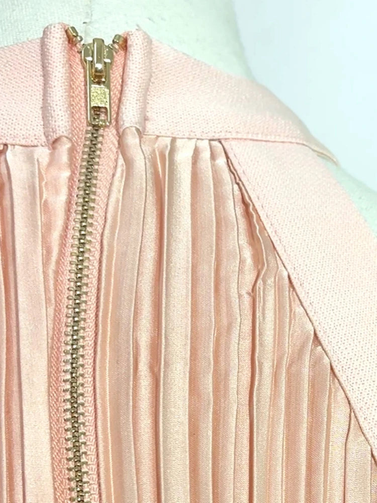 Close-up of a pink jacket with a zipper on a mannequin against a light blue background