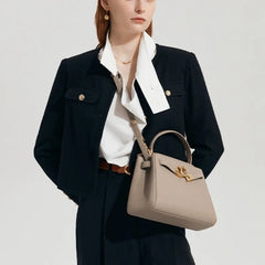 Gray structured top handle bag on a model.