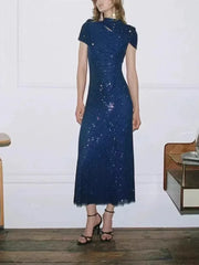 Dark blue sequin midi dress with a high neckline and cut-out detail.