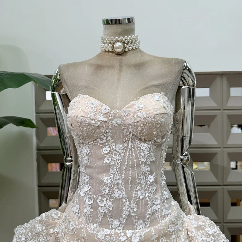 Close-up of ivory strapless floral lace mini dress bodice.