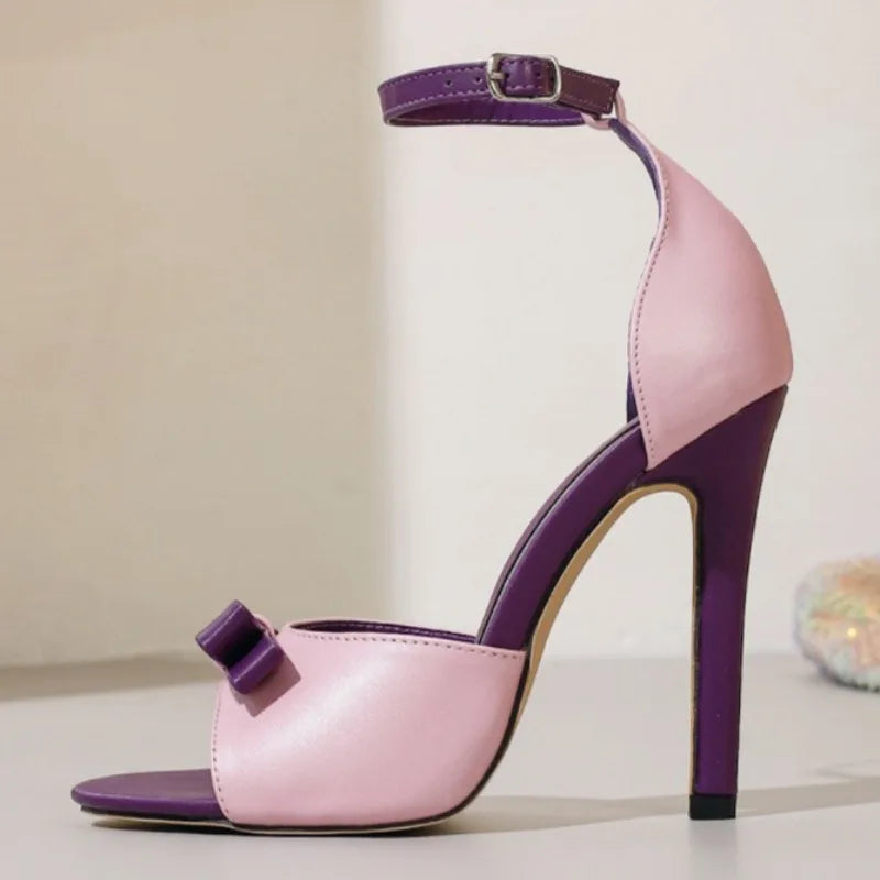 Side view of stiletto heeled sandals with bow detail