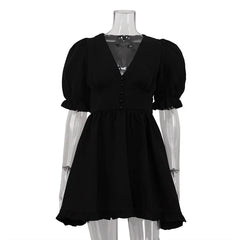 Black dress on a mannequin with sheer sleeves against a white background