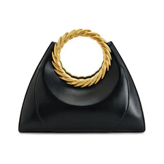 Front view of a black structured handbag with a gold ring handle