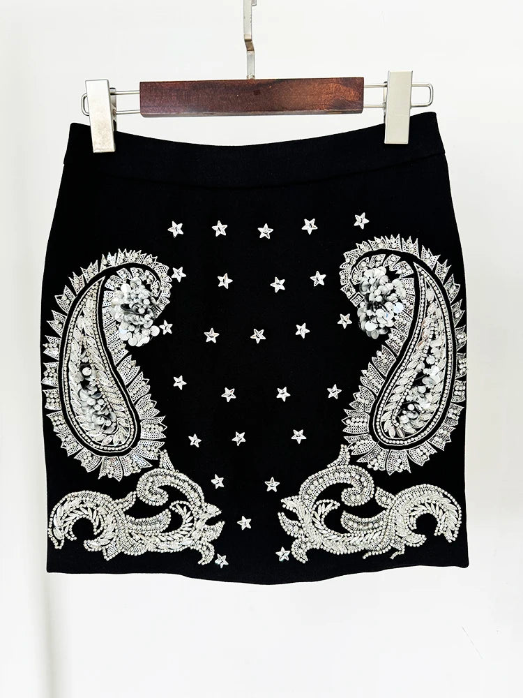 Close-up of embellished mini skirt with paisley and star details