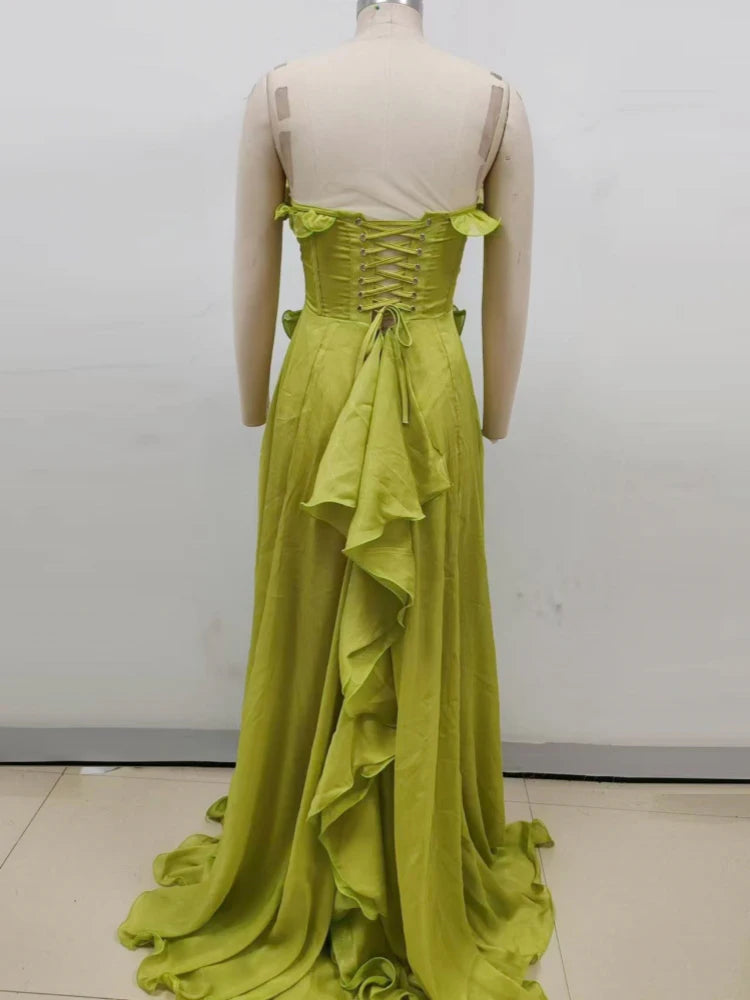 Green evening gown on a mannequin against a white background