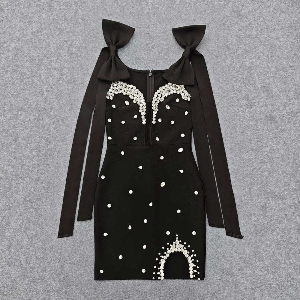 Black embellished bow strap mini dress laid flat