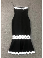 Black dress with white lace details on a gray background