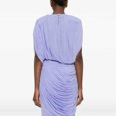 Person wearing a light purple draped dress on a white background