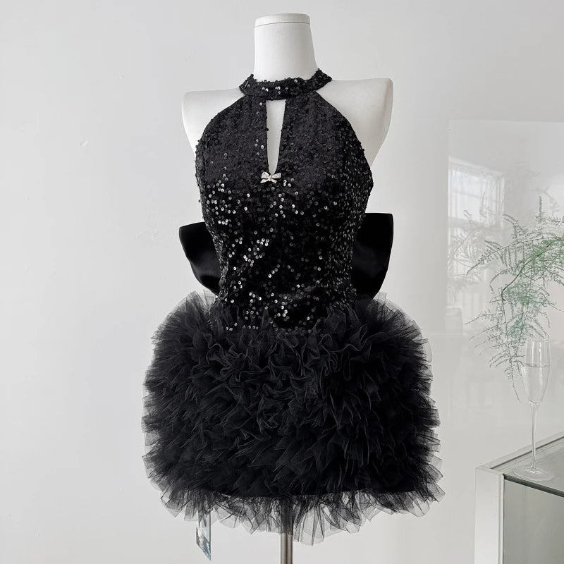 Sequin halter neck mini dress with ruffle skirt on mannequin