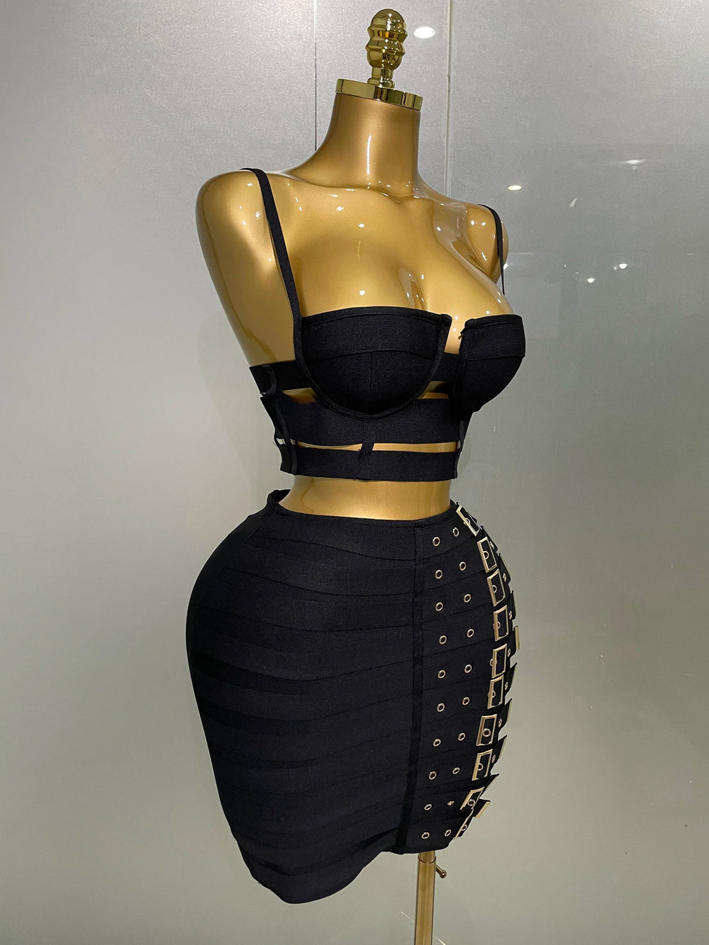 Black outfit on a mannequin against a plain background