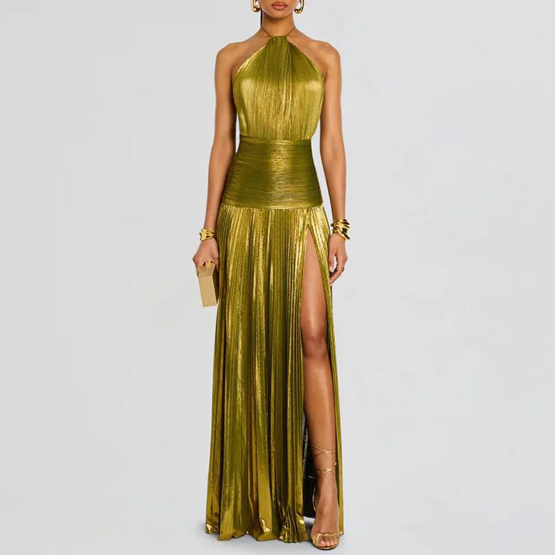 Woman wearing a gold green halter neck gown with a slit on a light gray background