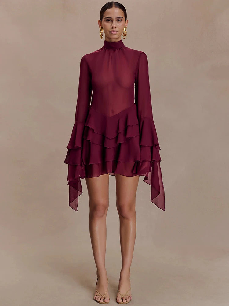 Maroon dress with ruffled layers on a beige background