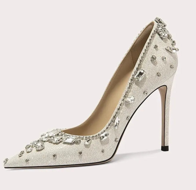 Elegant high-heeled shoe with crystal embellishments on a light background