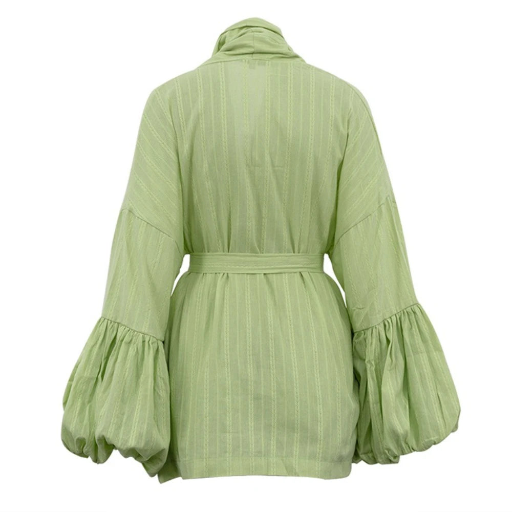 Green dress with ruffled sleeves on a white background