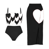 Black two-piece swimwear set with white heart print details and a matching high-waisted bottom.