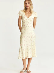 Woman wearing a floral dress on a white background