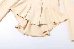 Beige blouse with ruffled details on a white background