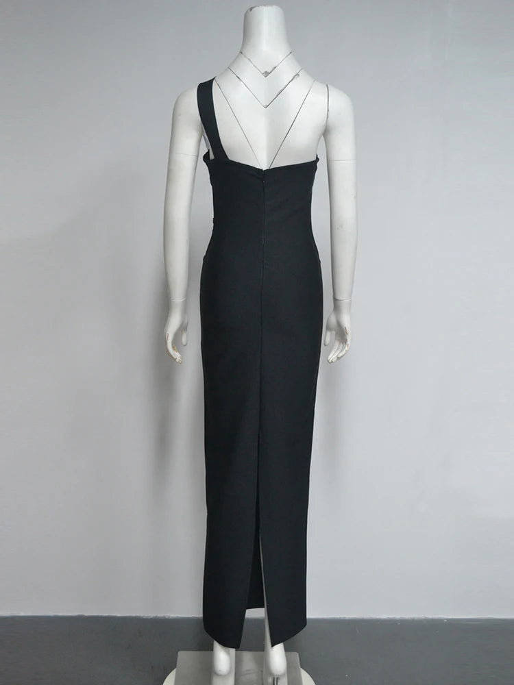 Black evening gown on a mannequin against a gray background