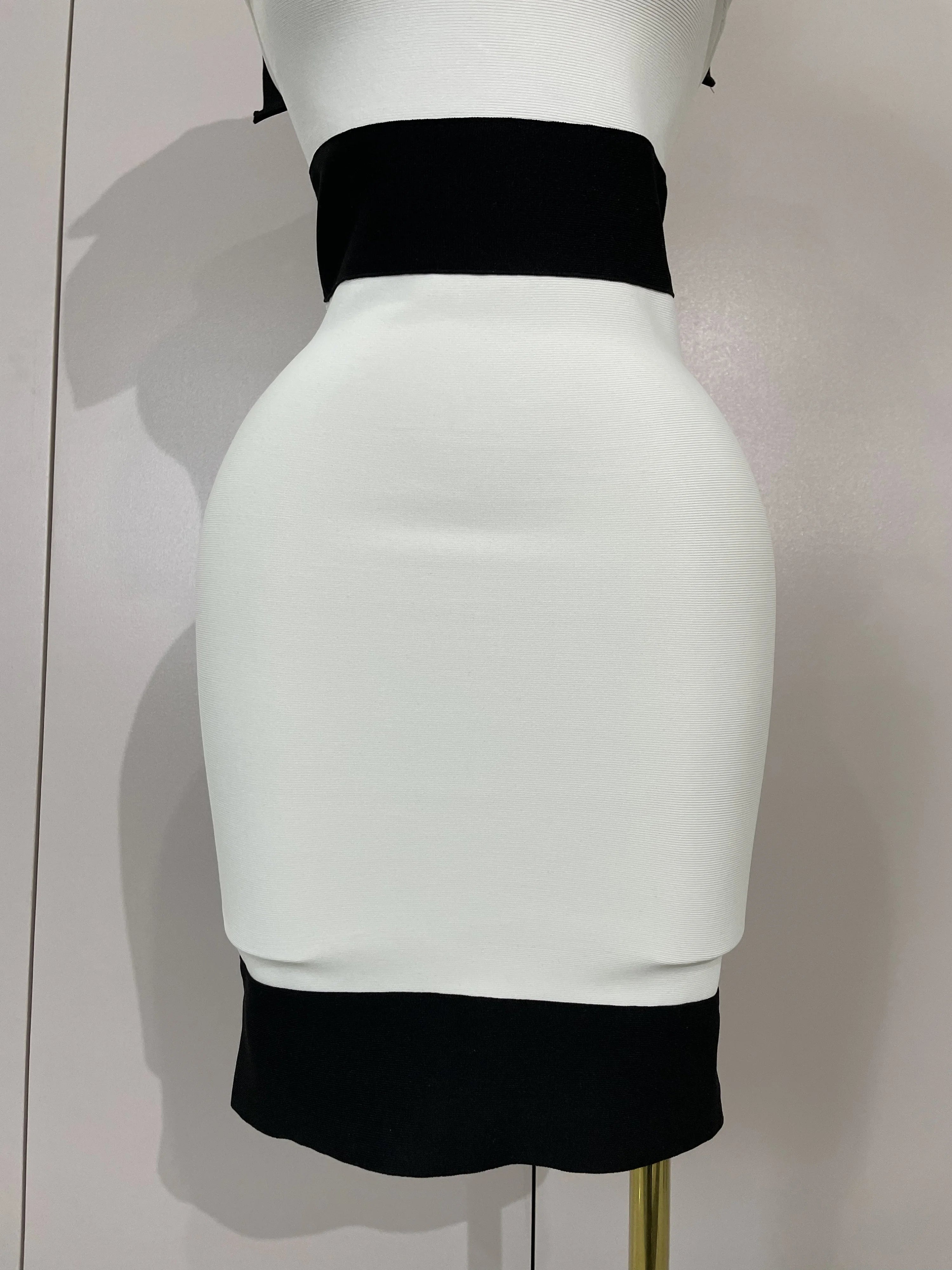 White and black two-tone skirt on a mannequin against a plain background