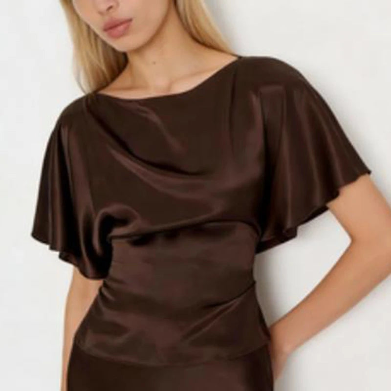 Woman wearing a brown satin dress against a white background