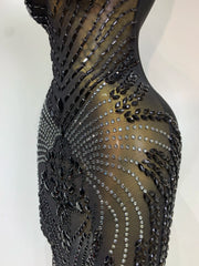 Black dress with intricate beadwork on a white background