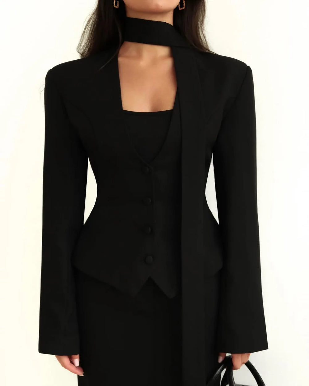 Black suit with cut-out design on a white background