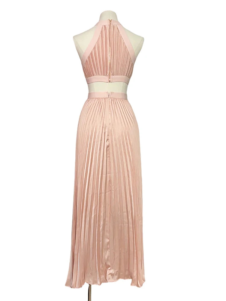Pink pleated dress on a mannequin against a white background