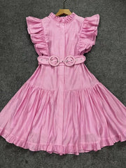 Pink dress with ruffled sleeves and waistband on a gray background