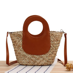 Woven handbag with brown leather patch on a white background