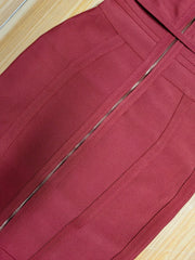 Close-up of a maroon skirt with a zipper on a wooden surface