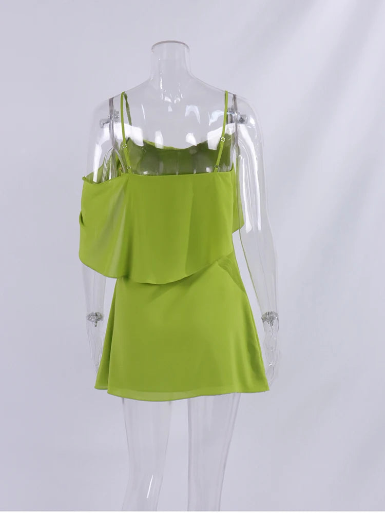 Green dress on a mannequin against a white background
