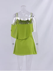 Green dress on a mannequin against a white background