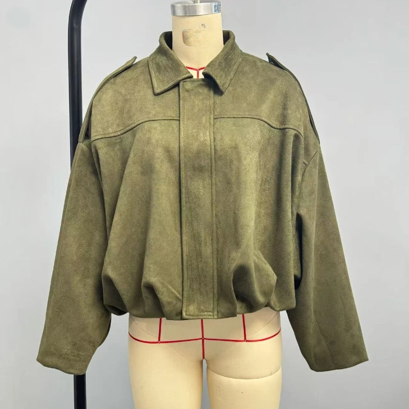 Green jacket on a mannequin with a plain background