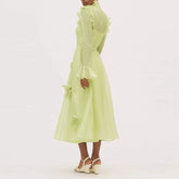 Light green dress with floral details on a white background