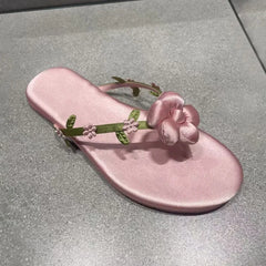 Close-up of pink floral embellishment on flip-flop