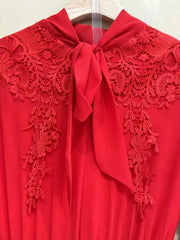 Red lace dress with a bow on a hanger