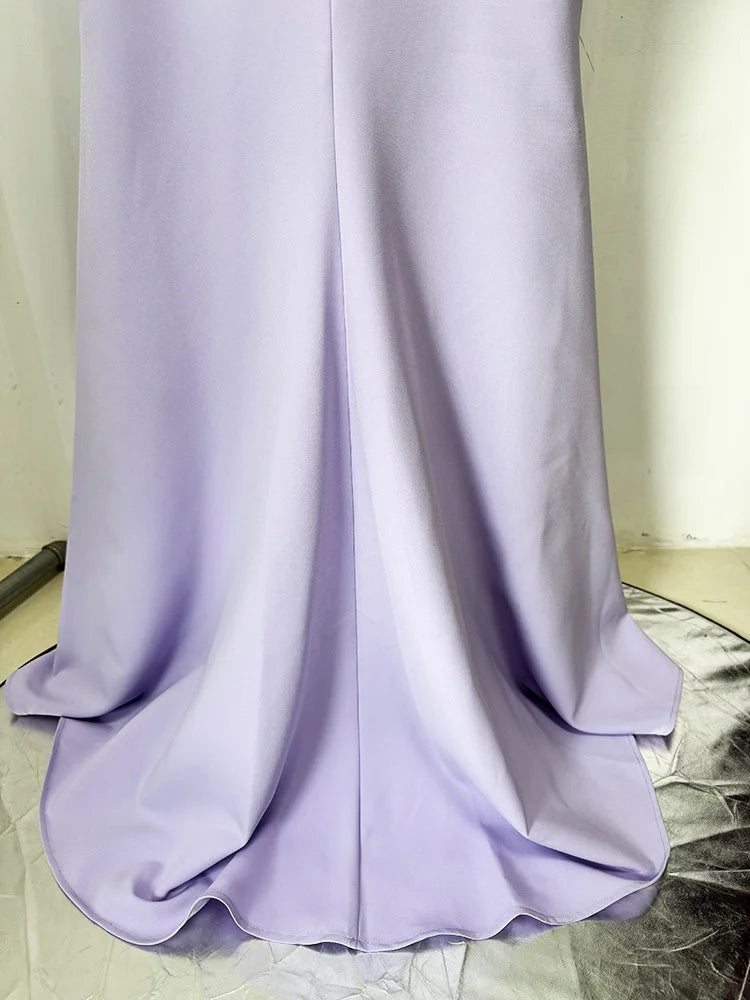 Lavender dress on a marble floor with a neutral wall background