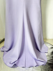 Lavender dress on a marble floor with a neutral wall background