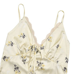 Cream-colored lace-trimmed top with floral patterns