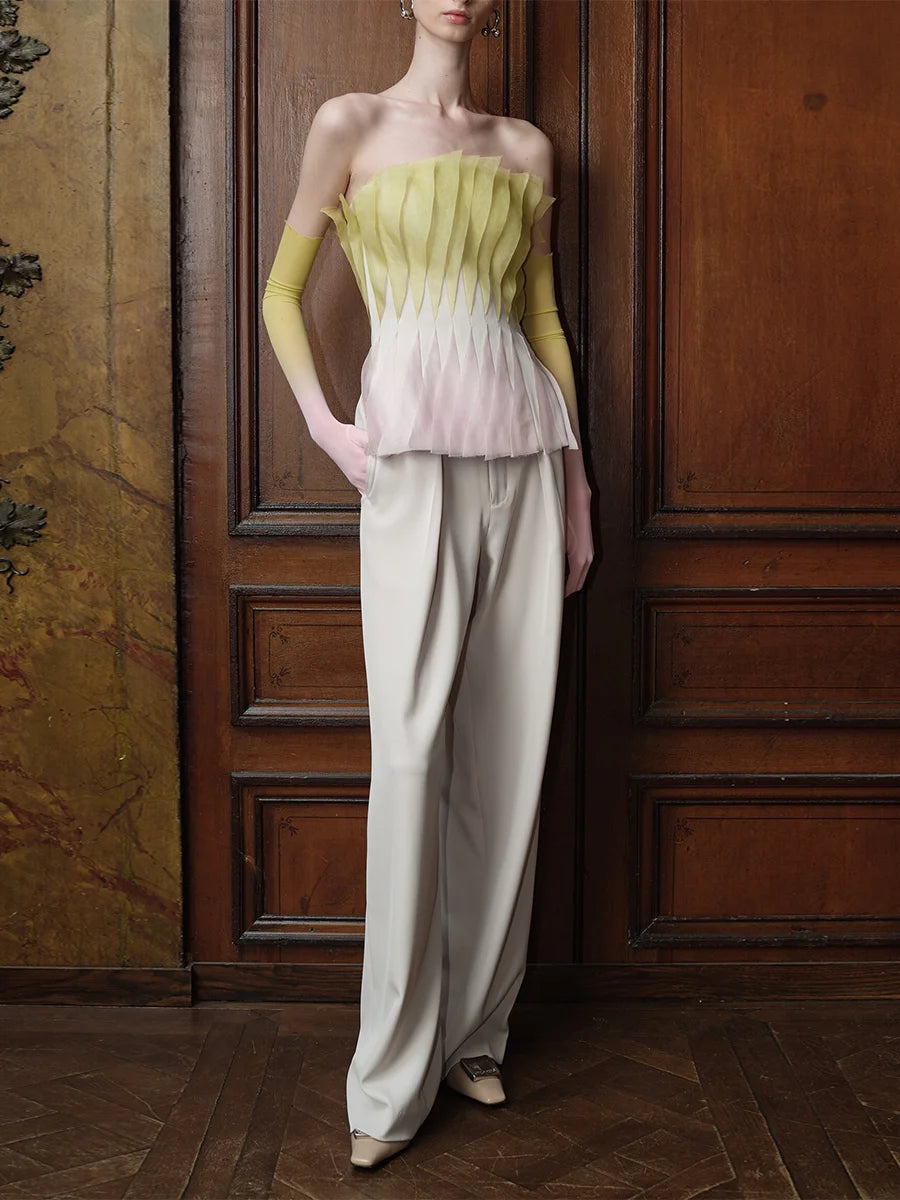 Model wearing pleated peplum strapless top with trousers