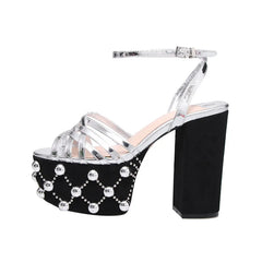 Silver metallic platform sandals with a black suede platform and decorative studs.