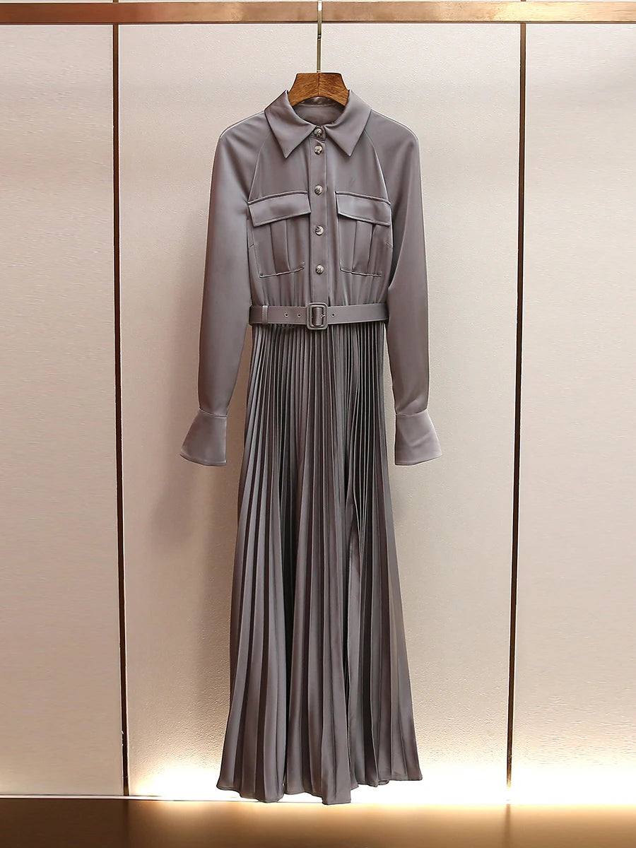 Gray dress with a jacket on a wooden hanger against a neutral background