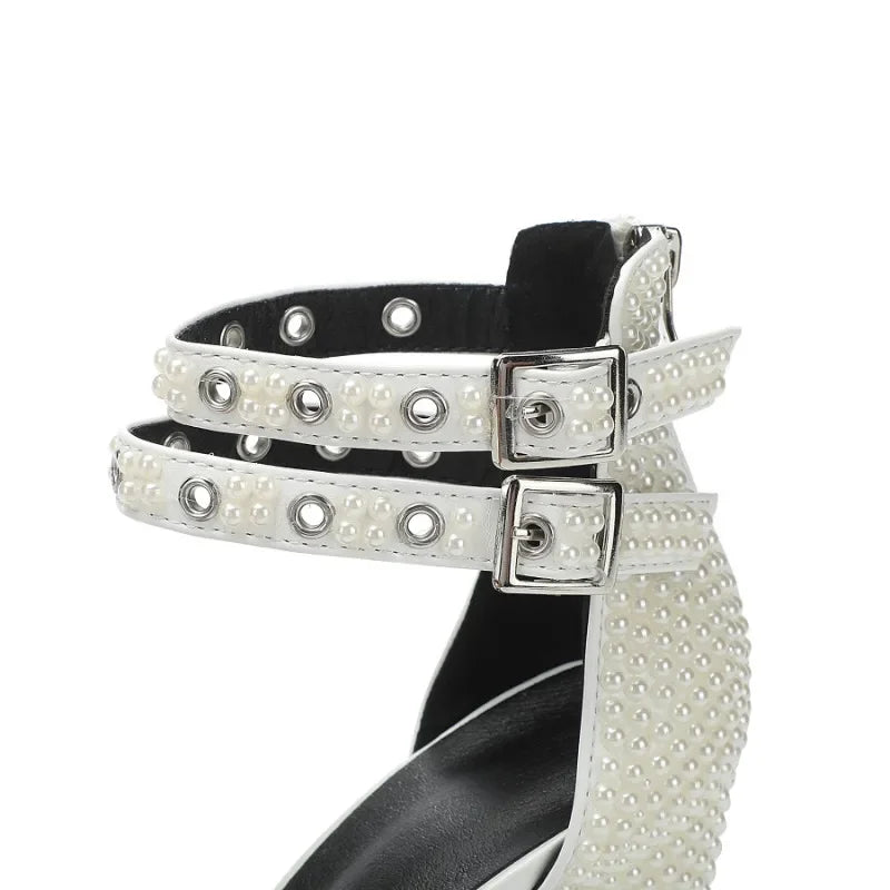 White studded sandal with black sole on a white background