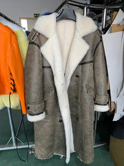 Gray coat with white fur lining on a hanger in a store setting