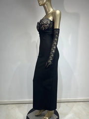Black evening gown with lace detailing on a mannequin against a white background