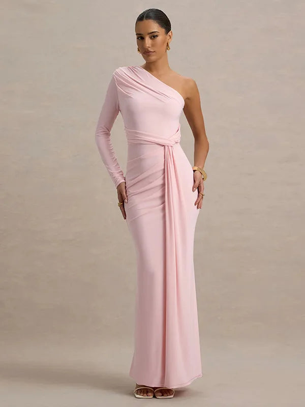 Woman wearing a pink one-shoulder gown against a plain background