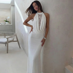 Woman in a white dress standing in a modern interior setting