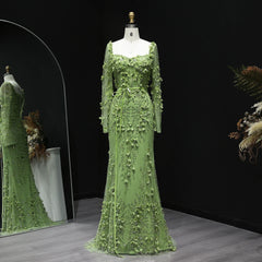Green lace dress on a mannequin against a dark background